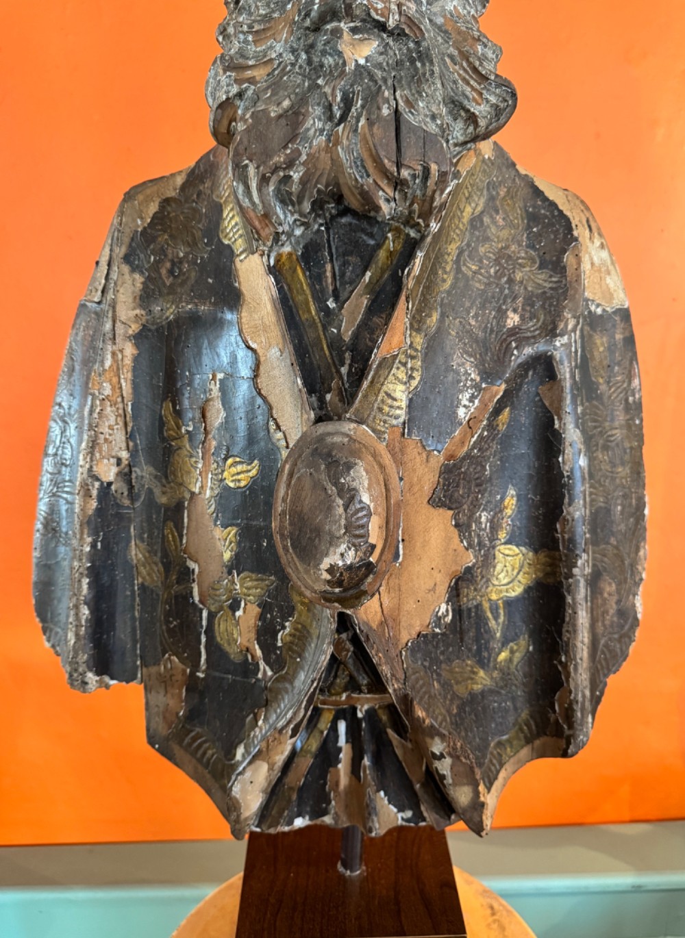 An eighteenth-century carved gilt-wood bust of a bearded bishop wearing a mitre, showing distressed gilding and mounted on a dark wooden block base. View VII