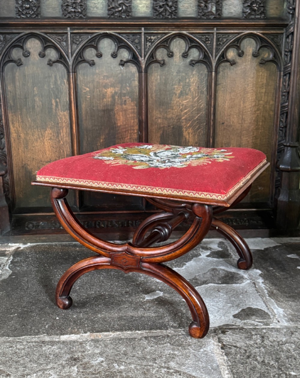 A Victorian walnut stool featuring curved X-frame legs, a turned central stretcher, and a red textile seat embellished with floral glass beadwork. View II