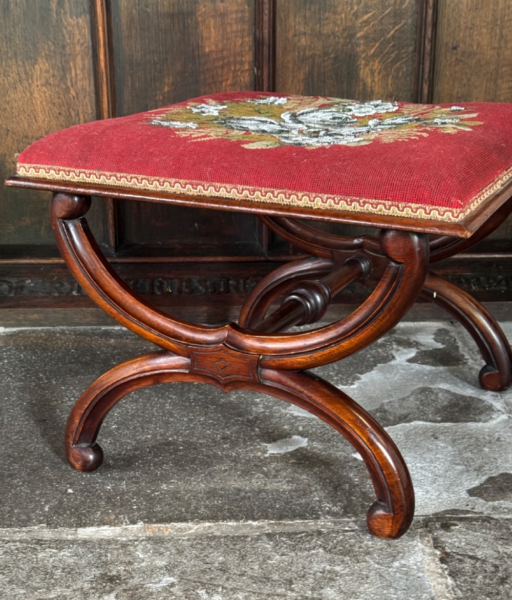 A Victorian walnut stool featuring curved X-frame legs, a turned central stretcher, and a red textile seat embellished with floral glass beadwork. View III