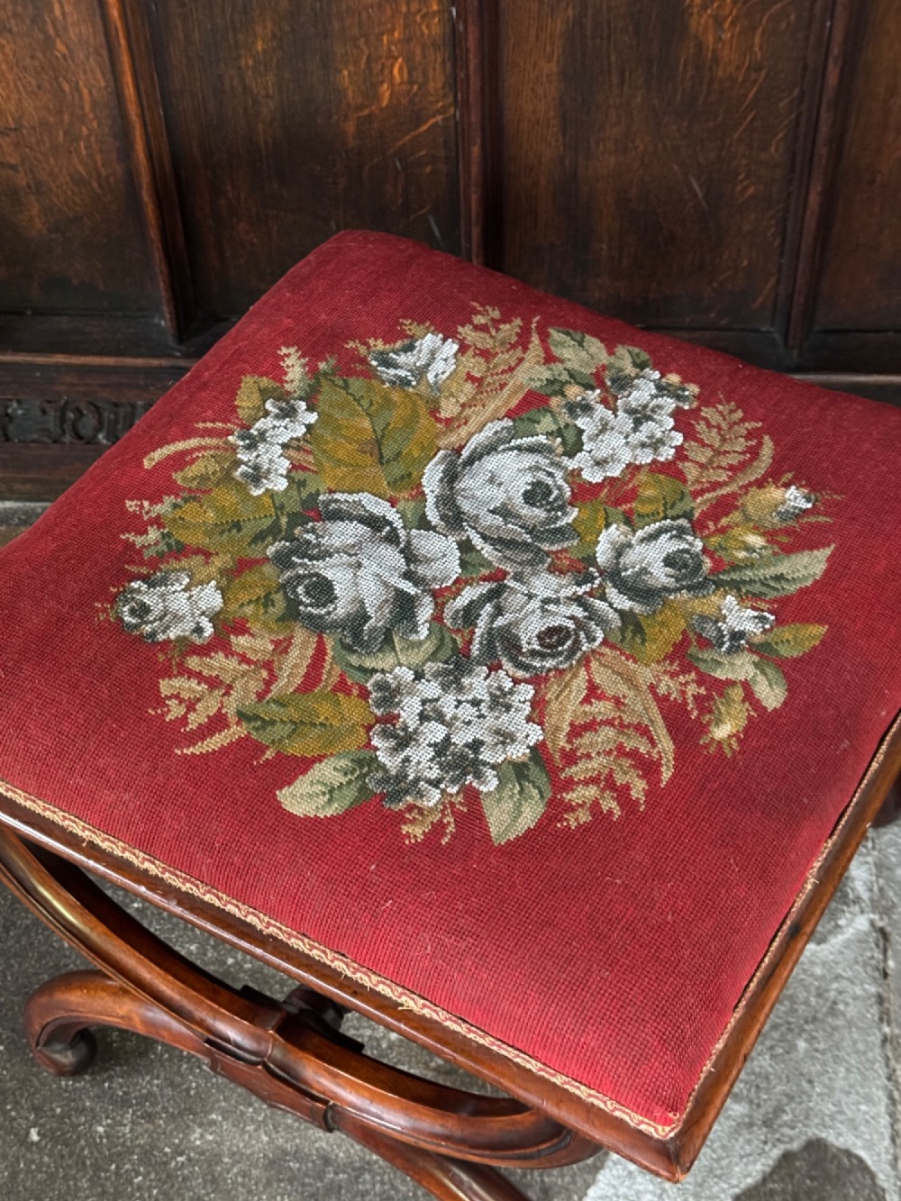 A Victorian walnut stool featuring curved X-frame legs, a turned central stretcher, and a red textile seat embellished with floral glass beadwork. View IV