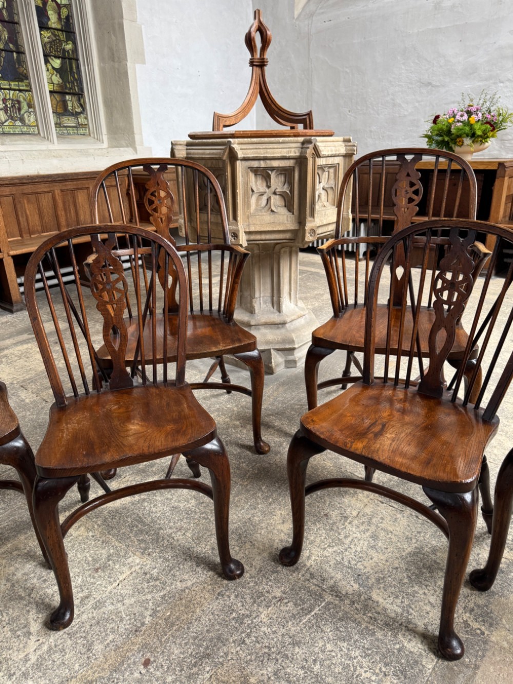 A set of six antique ash and beech Windsor chairs featuring arched backs with wheelback splats, shaped solid seats, and front cabriole legs. View IV