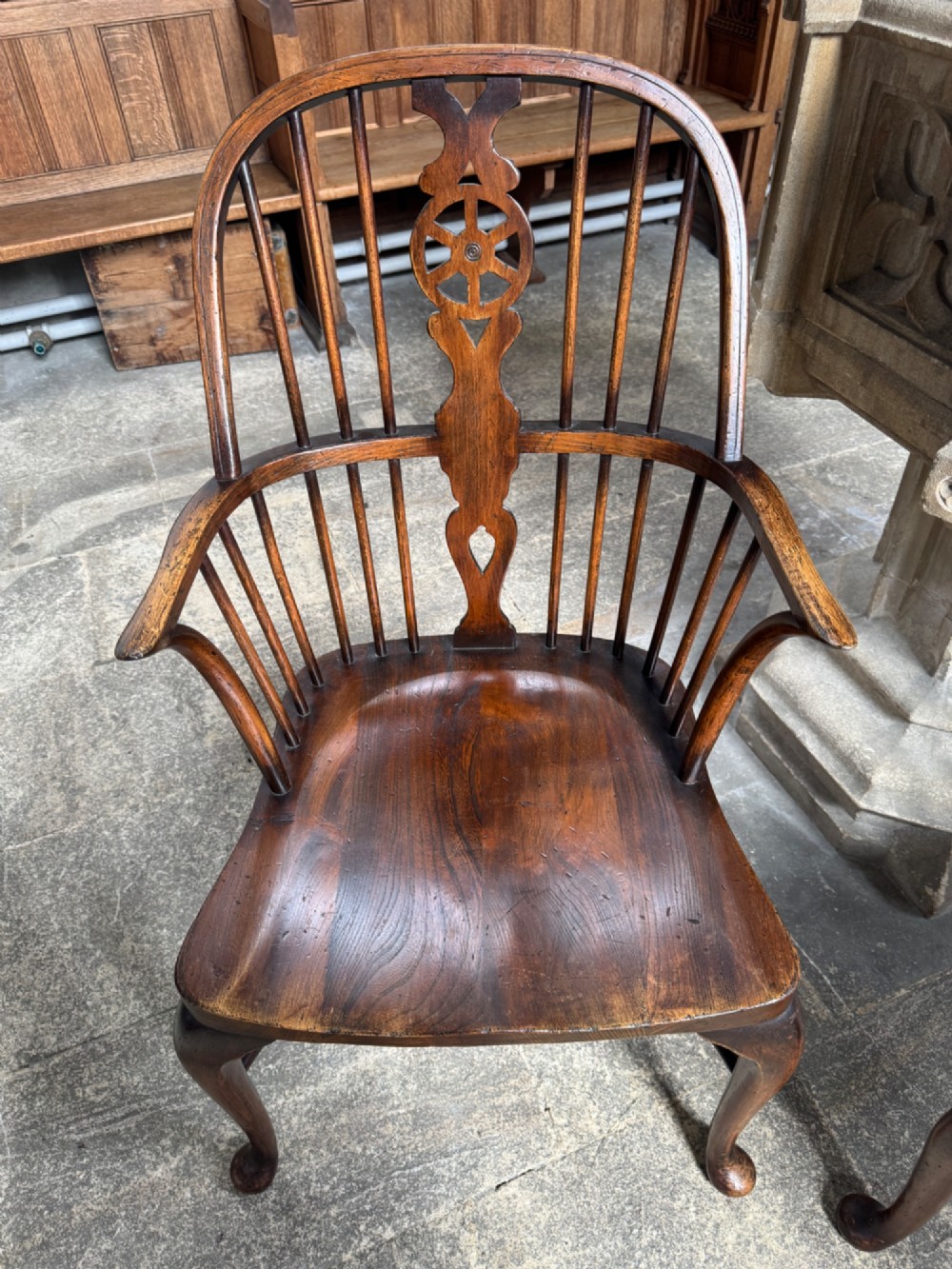 A set of six antique ash and beech Windsor chairs featuring arched backs with wheelback splats, shaped solid seats, and front cabriole legs. View VIII