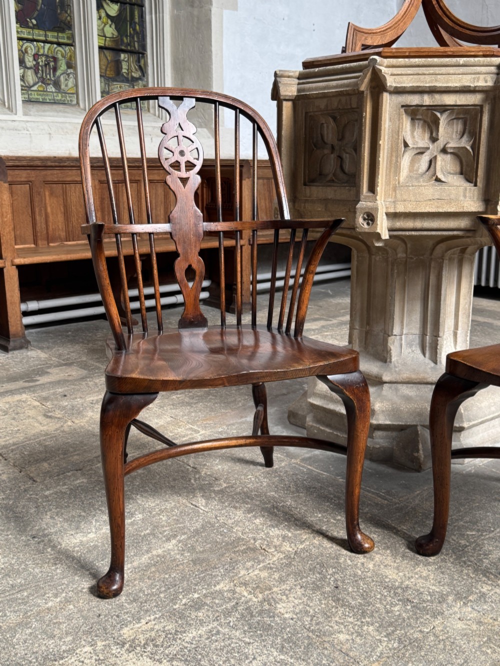 A set of six antique ash and beech Windsor chairs featuring arched backs with wheelback splats, shaped solid seats, and front cabriole legs. View IX
