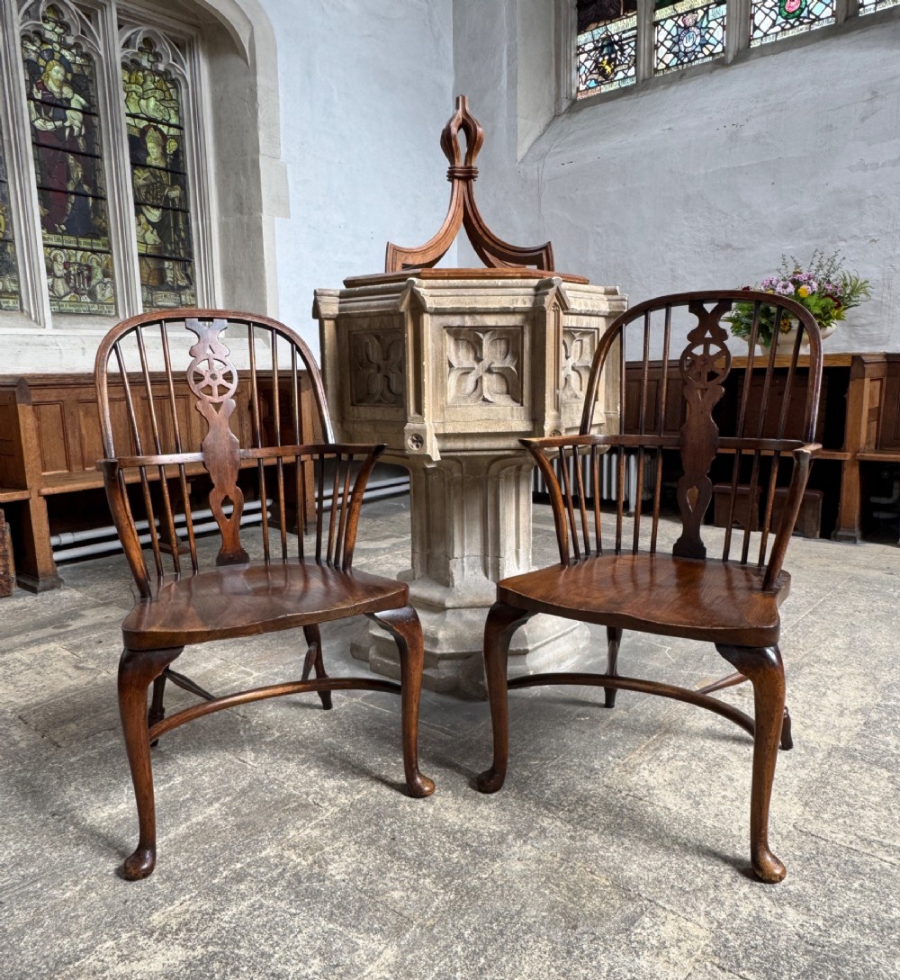 A set of six antique ash and beech Windsor chairs featuring arched backs with wheelback splats, shaped solid seats, and front cabriole legs. View X