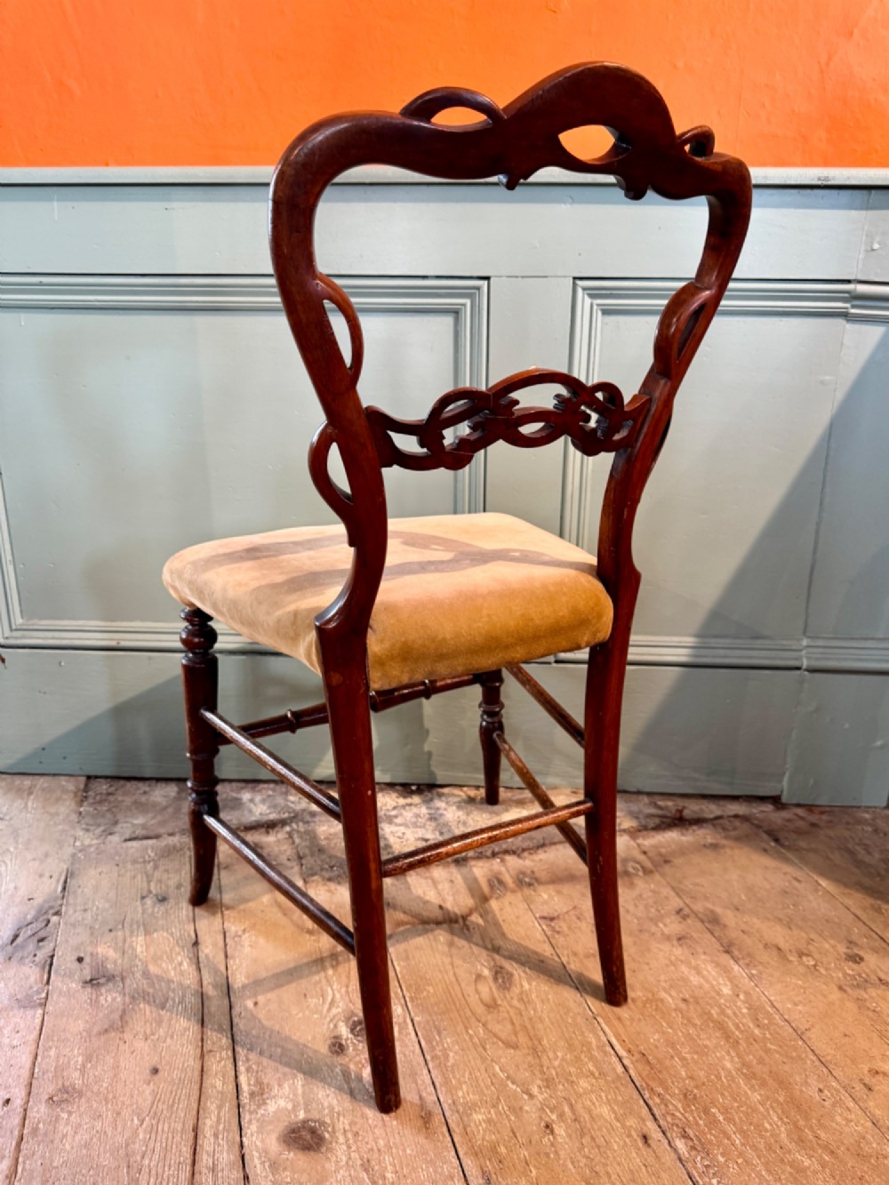 A pair of Victorian dark wood bedroom chairs with pierced scroll carved backrests, dot inlay, turned legs, and velvet seats. View II