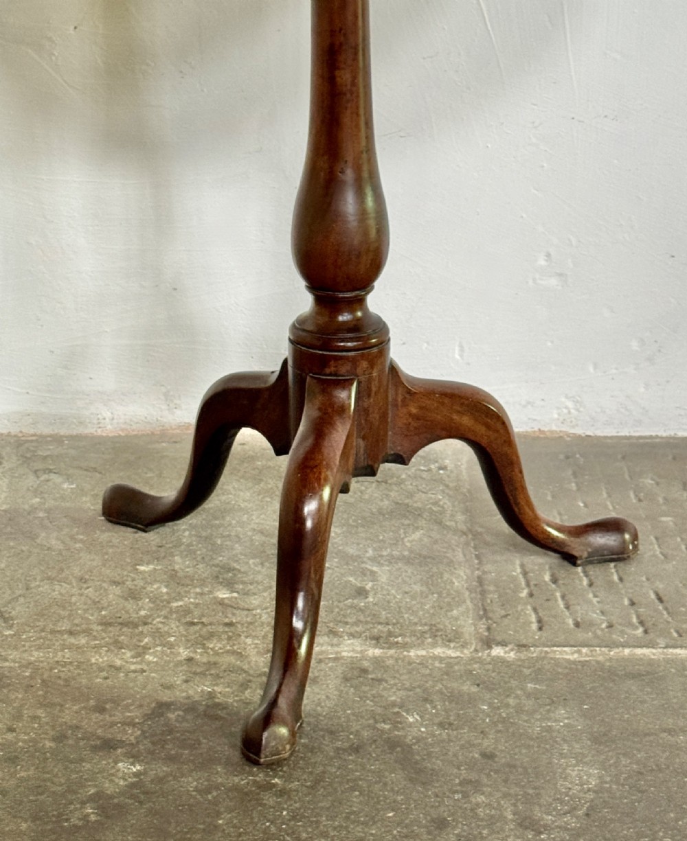A Georgian mahogany tilt-top tripod table featuring a circular dished top supported by a turned pedestal stem and three cabriole legs. View IV