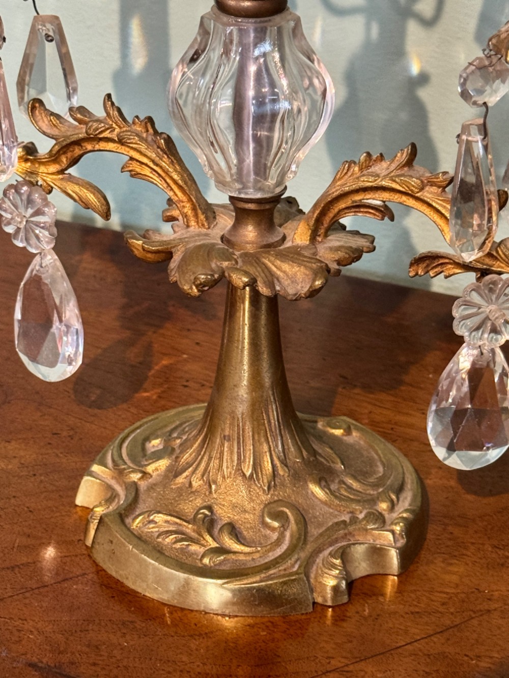 A pair of French gilt-brass two-arm candlestick lustres featuring central crystal elements and hanging cut-crystal drop prisms. View III