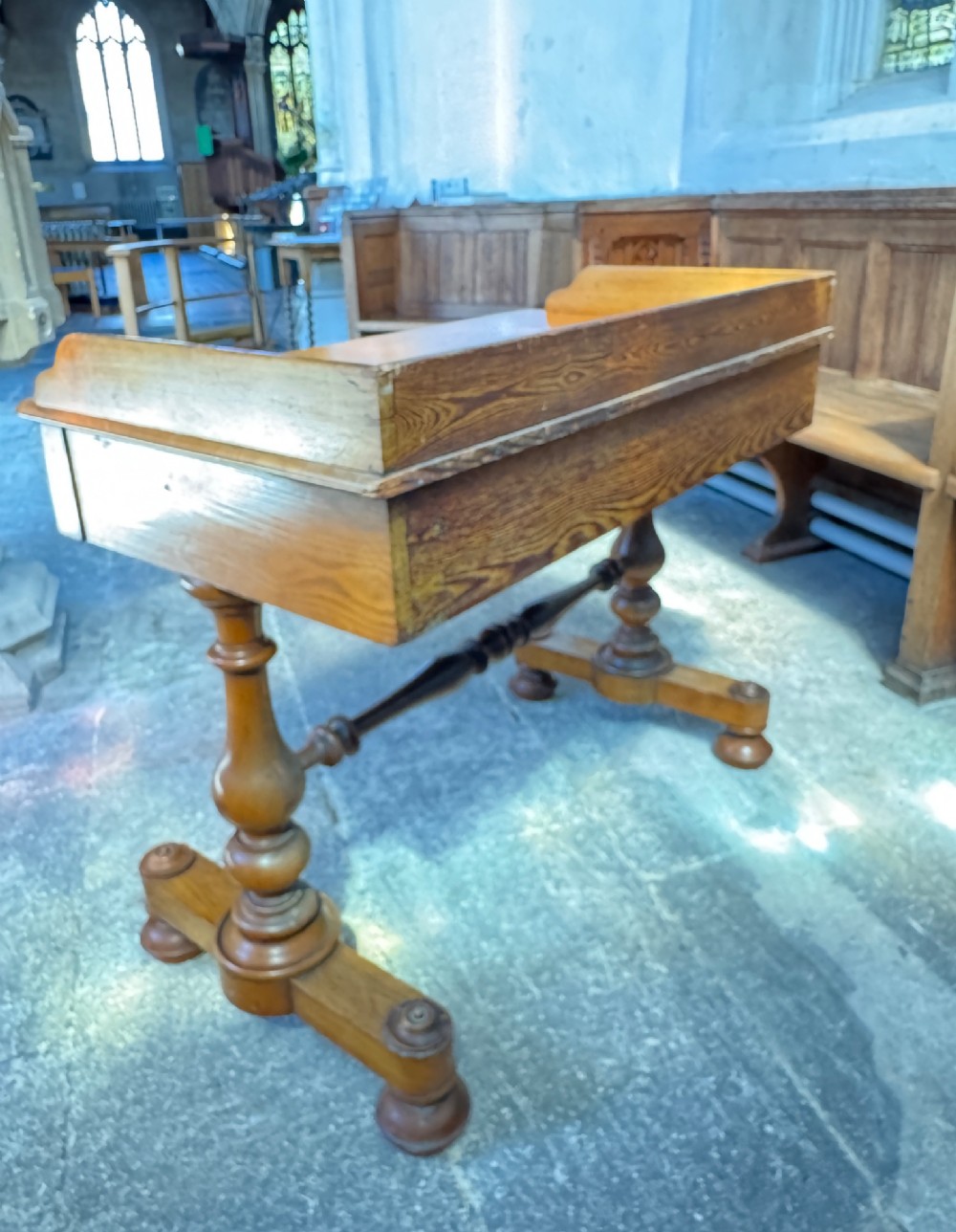 A Victorian pitch pine washstand featuring a raised gallery splashback, a single wide drawer with wooden knobs, and turned trestle legs connected by a stretcher. View VIII