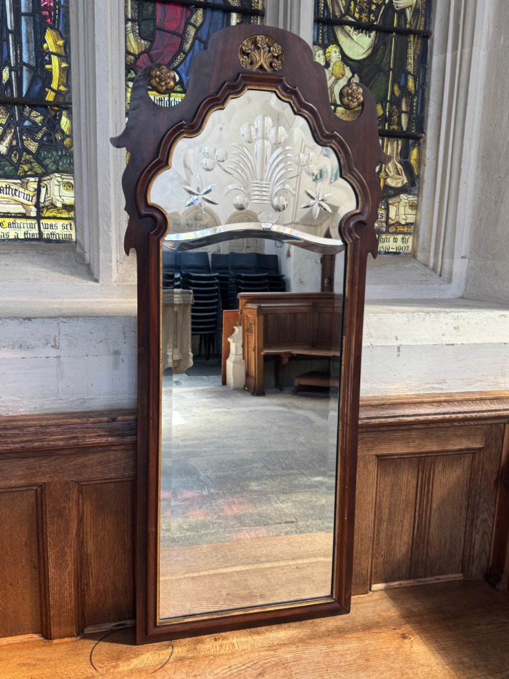 A tall Georgian style mahogany pier mirror featuring parcel gilt detailing, a scroll-carved crest with gold rosettes, and an upper glass section with reverse-cut botanical motifs. View II