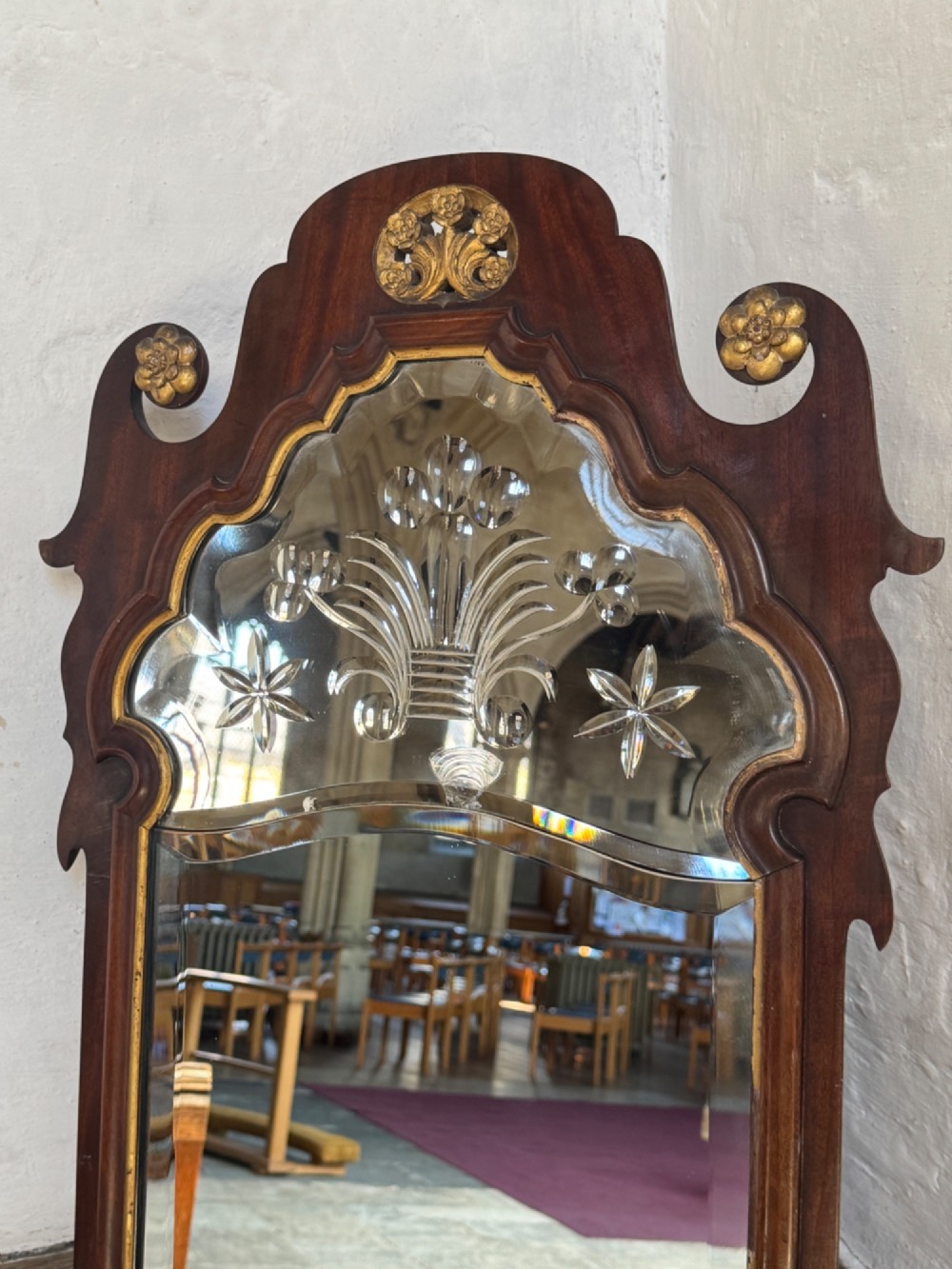 A tall Georgian style mahogany pier mirror featuring parcel gilt detailing, a scroll-carved crest with gold rosettes, and an upper glass section with reverse-cut botanical motifs. View III