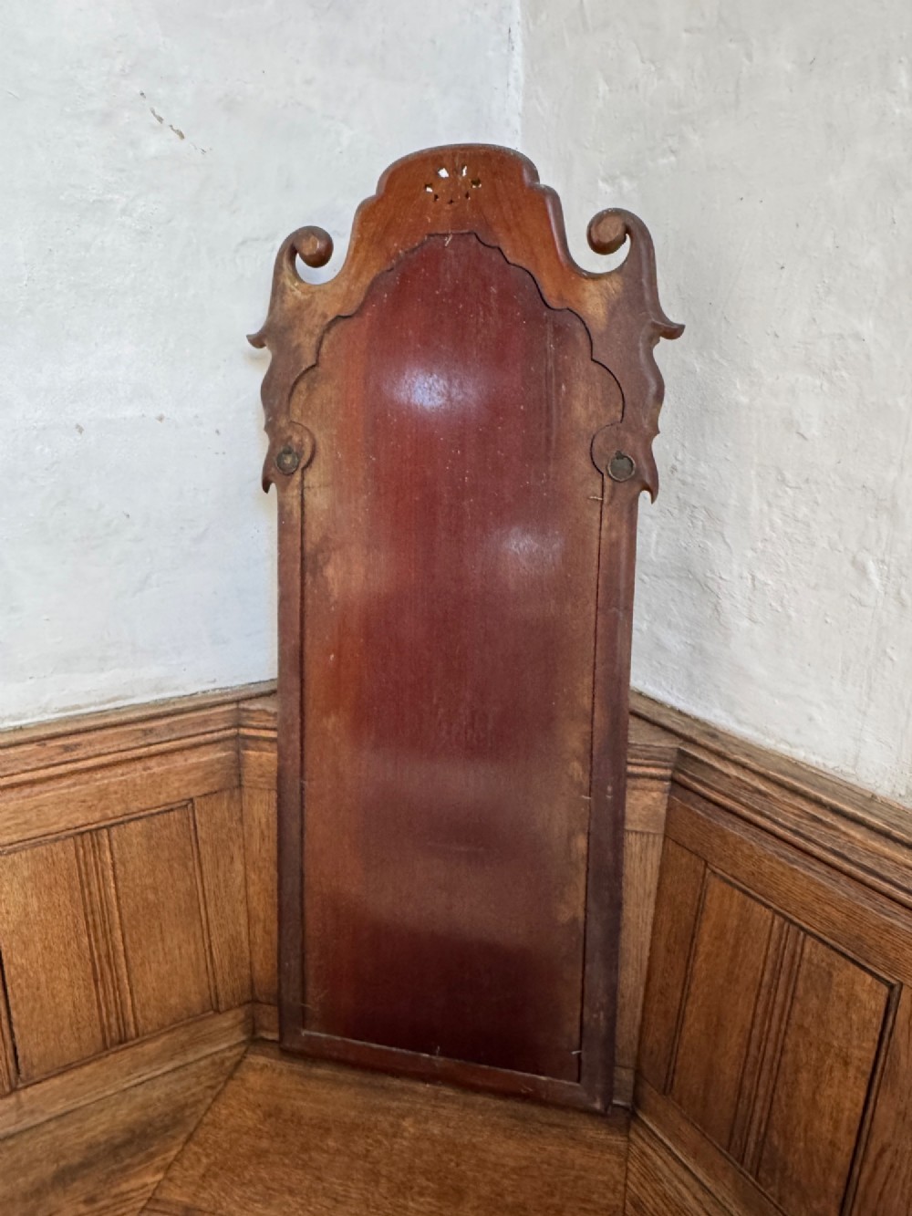 A tall Georgian style mahogany pier mirror featuring parcel gilt detailing, a scroll-carved crest with gold rosettes, and an upper glass section with reverse-cut botanical motifs. View V