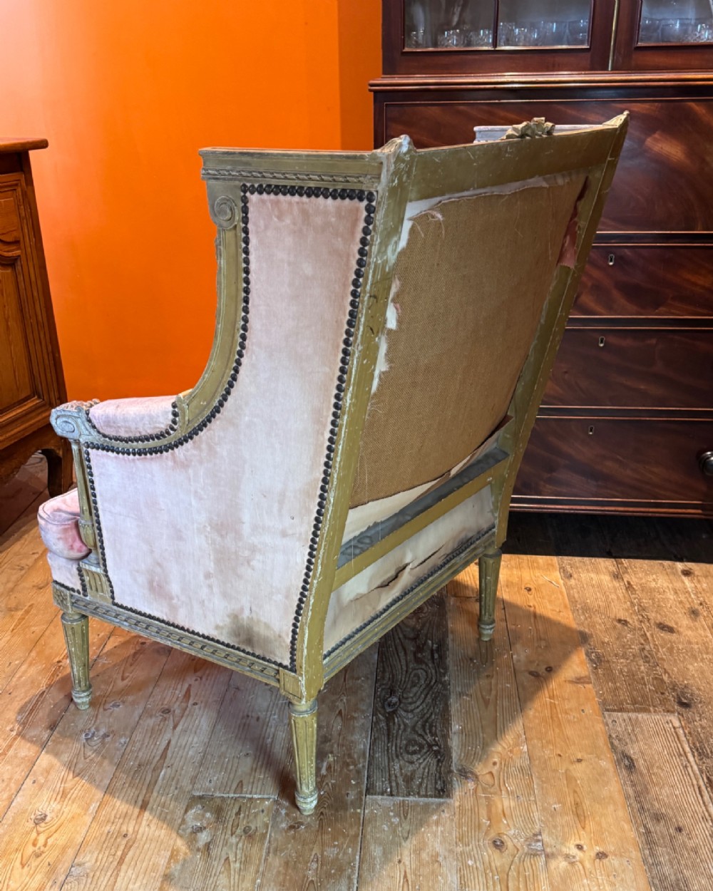 An antique Louis XVI French bergere armchair with a grey painted carved wood frame and dusty pink velvet upholstery. View VII