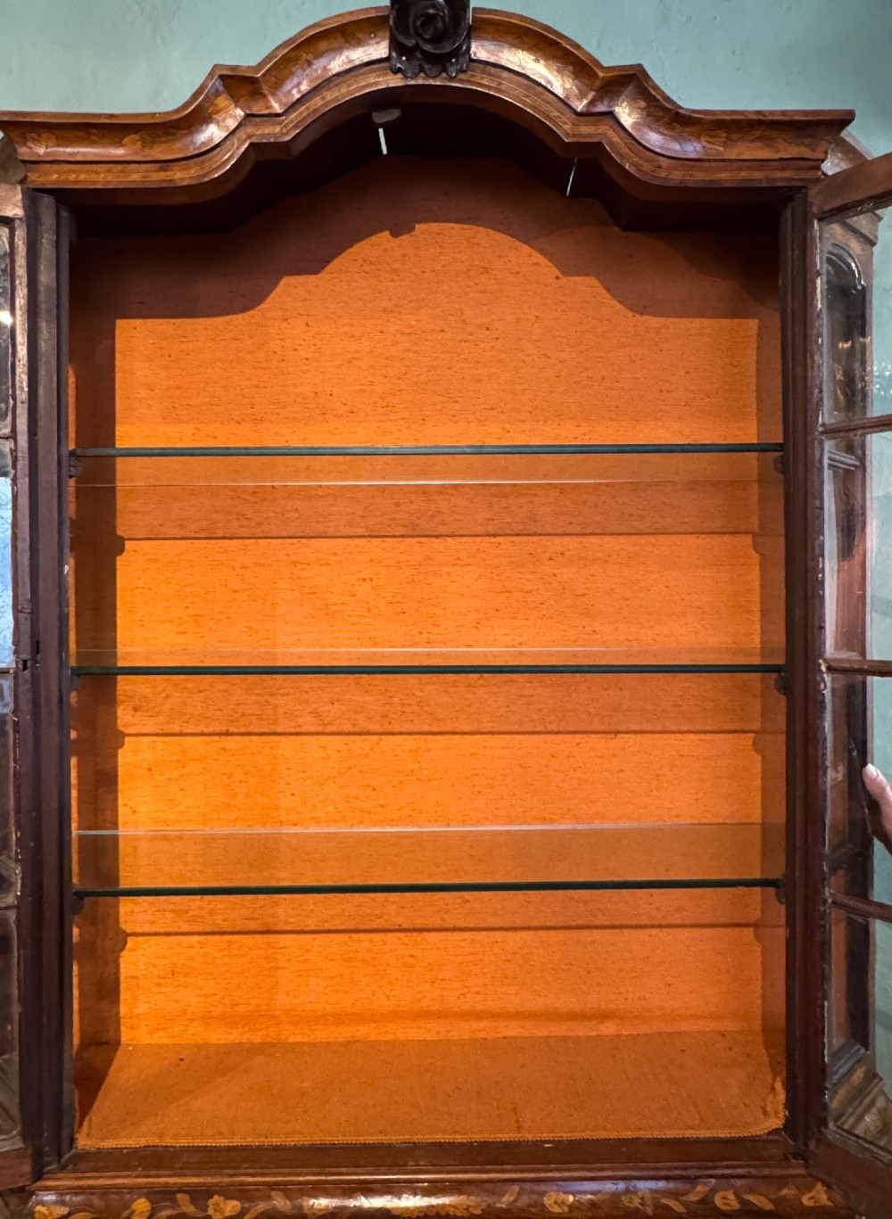 An antique Dutch walnut display cabinet featuring intricate floral marquetry inlays, glazed upper doors, and a double cupboard lower section supported by bun feet. View V