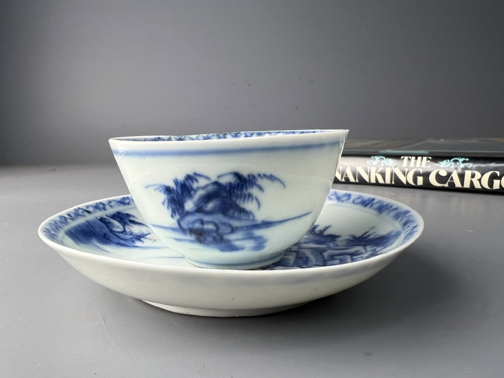 An 18th-century Chinese export blue and white porcelain tea bowl resting inside its matching hand-painted saucer. View III
