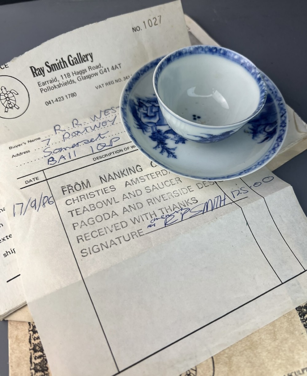 An 18th-century Chinese export blue and white porcelain tea bowl resting inside its matching hand-painted saucer. View IV