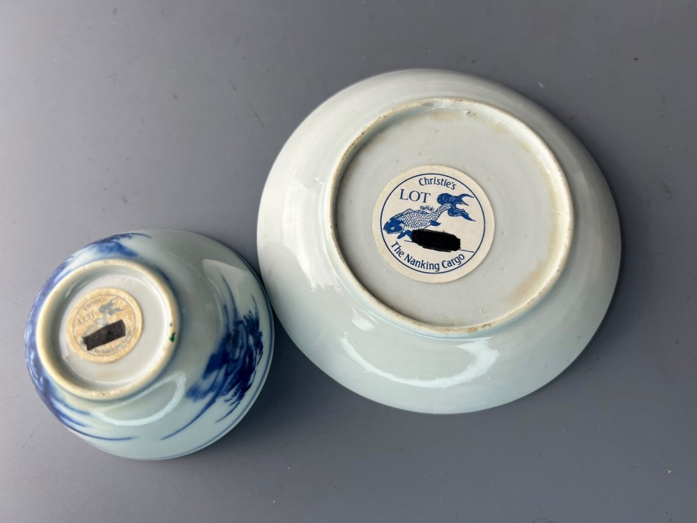 An 18th-century Chinese export blue and white porcelain tea bowl resting inside its matching hand-painted saucer. View V