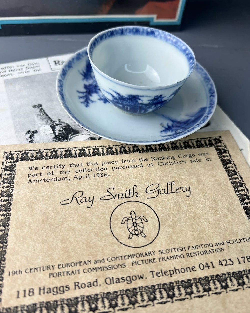 An 18th-century Chinese export blue and white porcelain tea bowl resting inside its matching hand-painted saucer. View VII