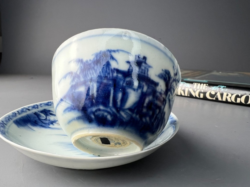 An 18th-century Chinese export blue and white porcelain tea bowl resting inside its matching hand-painted saucer. View VIII