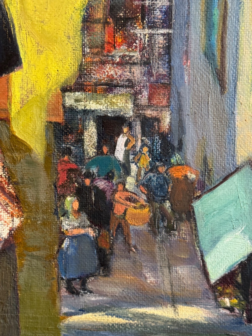 A mid-century oil painting on board depicting a narrow street in Antibes with terracotta roofs and distant mountains, housed in a grey and timber wooden frame. View IV