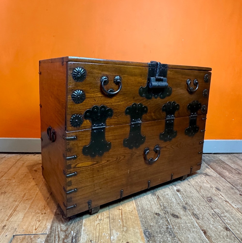 An antique wooden Korean Bandaji chest fitted with black iron strap hinges, decorative round bosses, and drop handles. View II