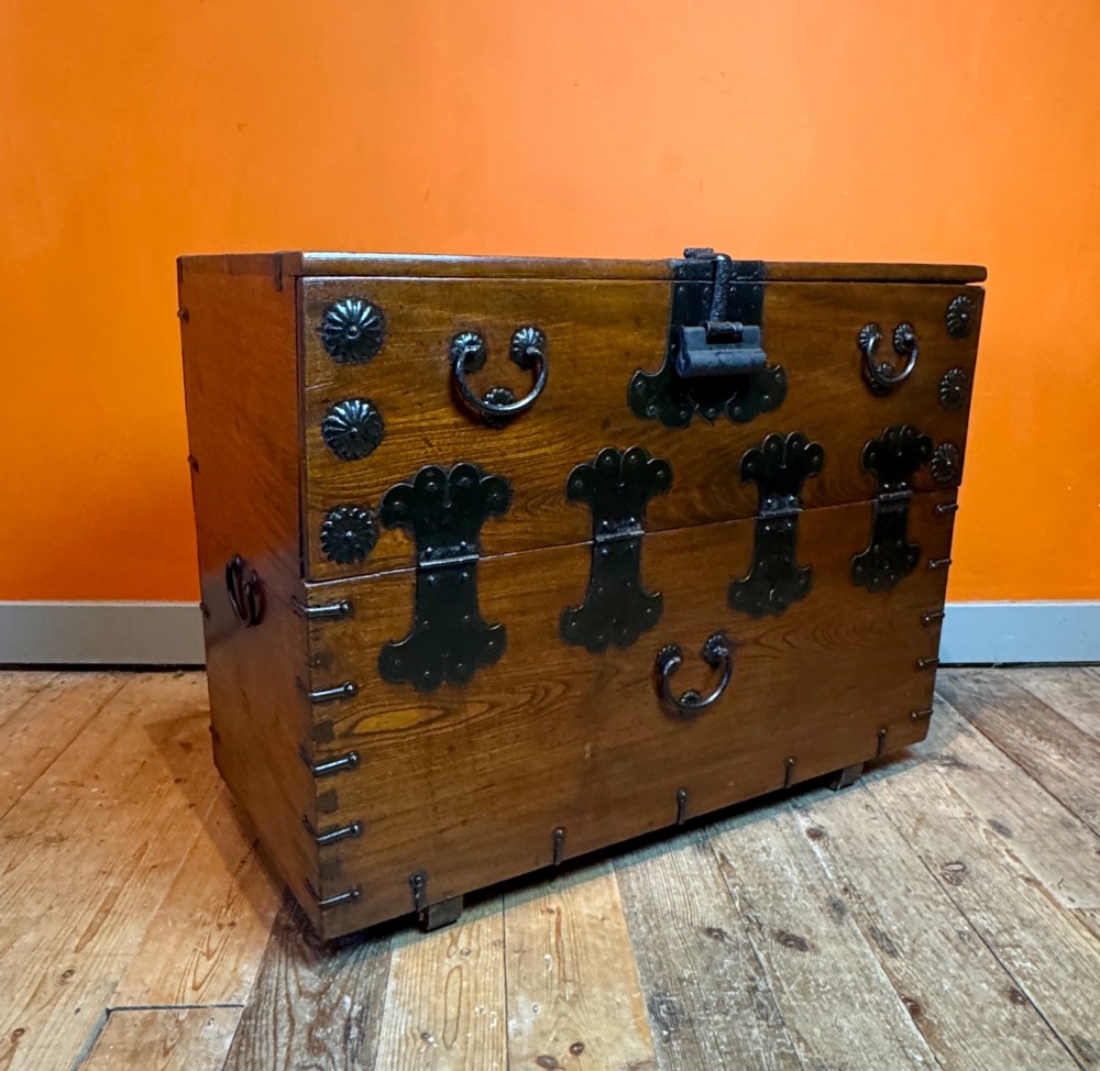 An antique wooden Korean Bandaji chest fitted with black iron strap hinges, decorative round bosses, and drop handles. View III