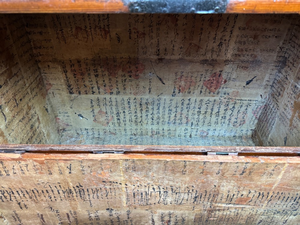 An antique wooden Korean Bandaji chest fitted with black iron strap hinges, decorative round bosses, and drop handles. View V