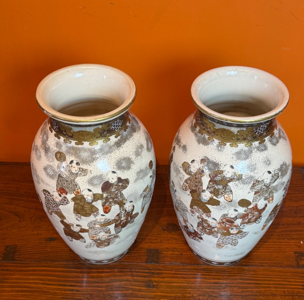 A pair of baluster-shaped Japanese Satsuma earthenware vases featuring hand-painted figures in the Hundred Boys pattern with gilded borders and a crackle glaze. View II