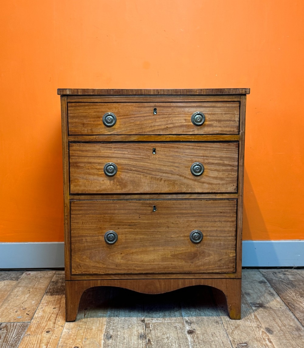 A small Regency satinwood chest of three graduated drawers with brass handles and string inlay. View II