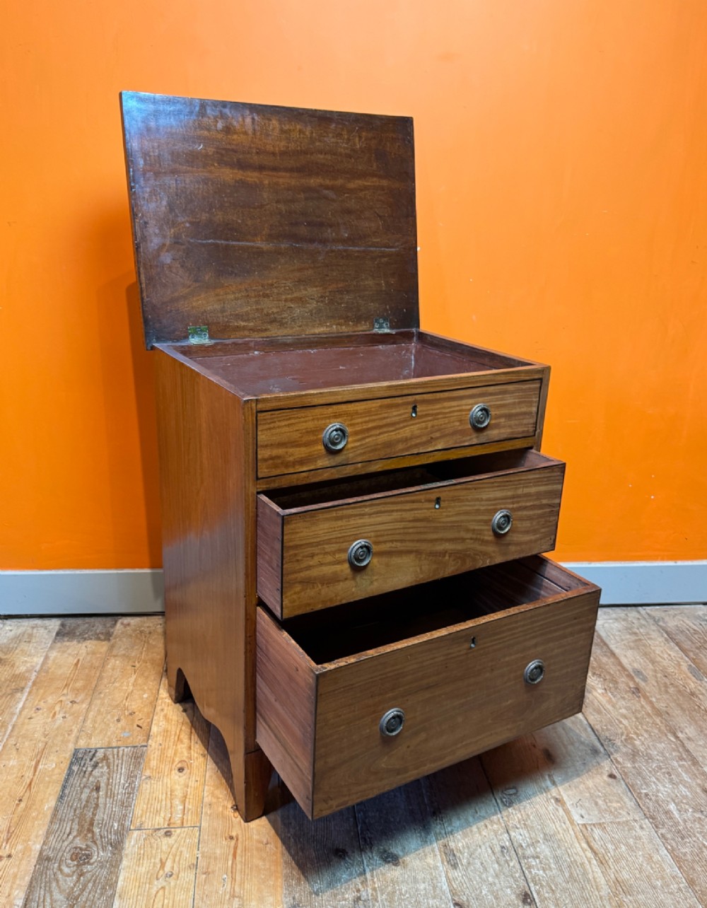 A small Regency satinwood chest of three graduated drawers with brass handles and string inlay. View V