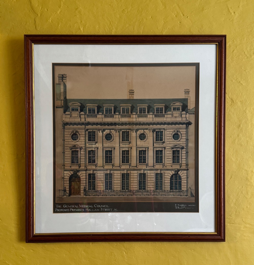 A framed architectural watercolour drawing depicting the front elevation of a Classical-style building with detailed windows and a formal title block. View III