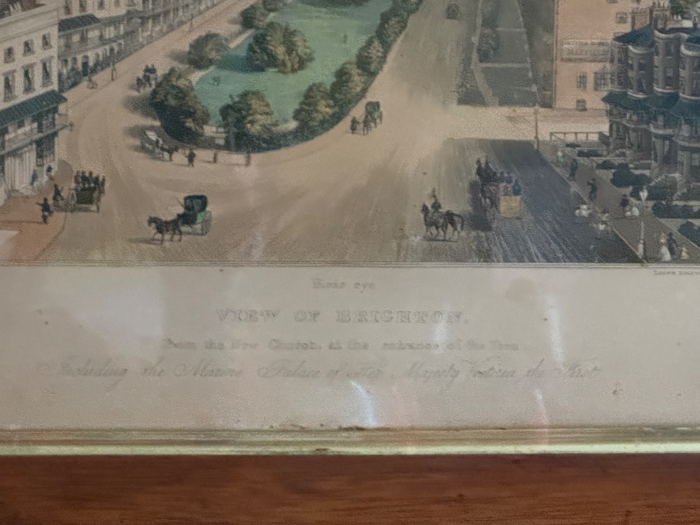 A framed nineteenth-century aquatint depicting an aerial view of Brighton, presented in a dark wooden frame with a gilded inner slip. View IV