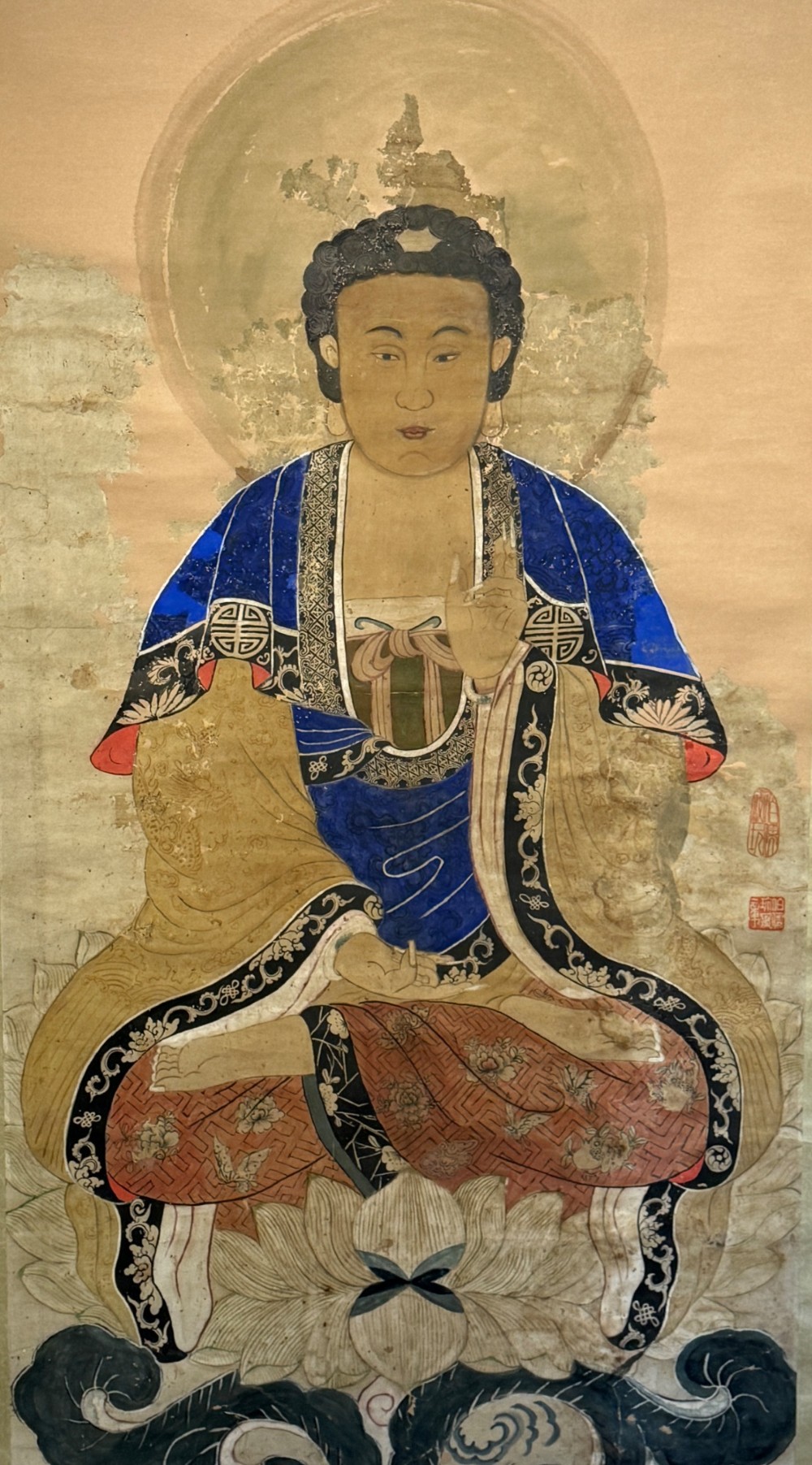 A 19th-century Chinese hanging scroll painting depicting Buddha Shakyamuni seated cross-legged on a lotus throne in blue and gold robes. View III