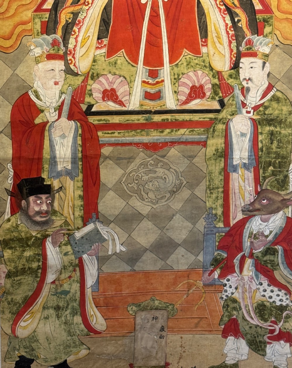 A vertical 19th-century Chinese hanging scroll painting on a pale silk mount depicting an enthroned Daoist judge surrounded by court attendants and mythological figures in red and green ceremonial robes. View V