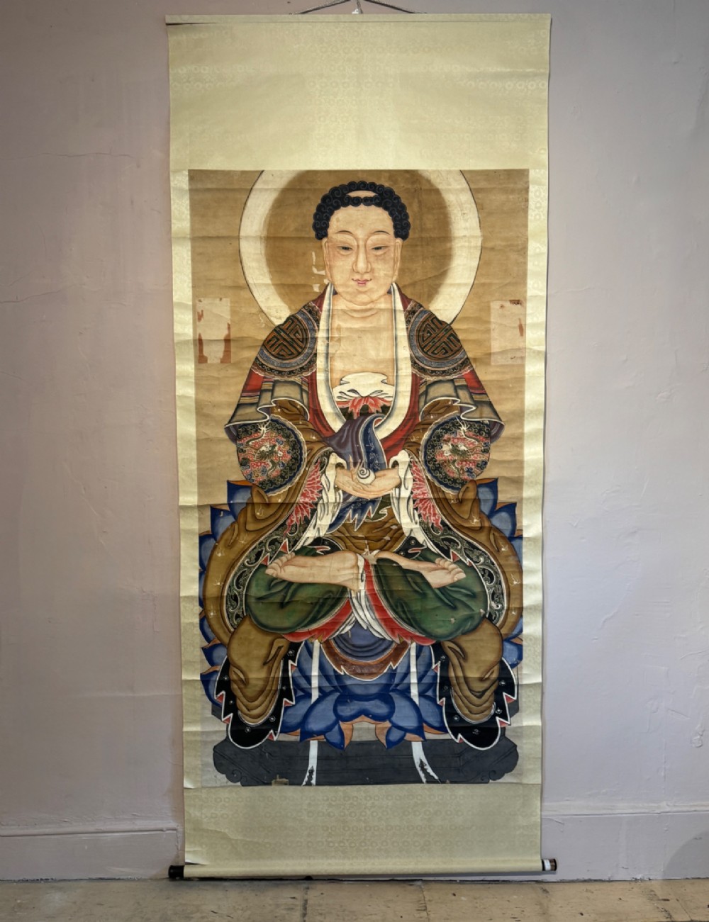 A 19th-century Chinese hanging scroll depicting Buddha Shakyamuni seated on a lotus throne painted in mineral pigments with silk mounting. View II
