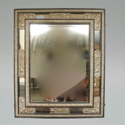 A Large Flemish Ebonised Ripple Cushion Mirror with Silvered Repousse' Decoration