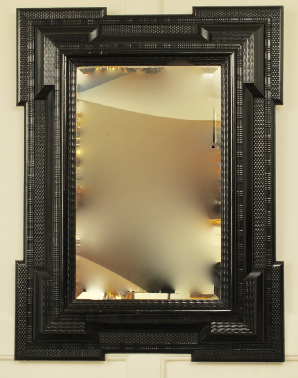 Large early 19th century ebonised ripple frame mirror.
