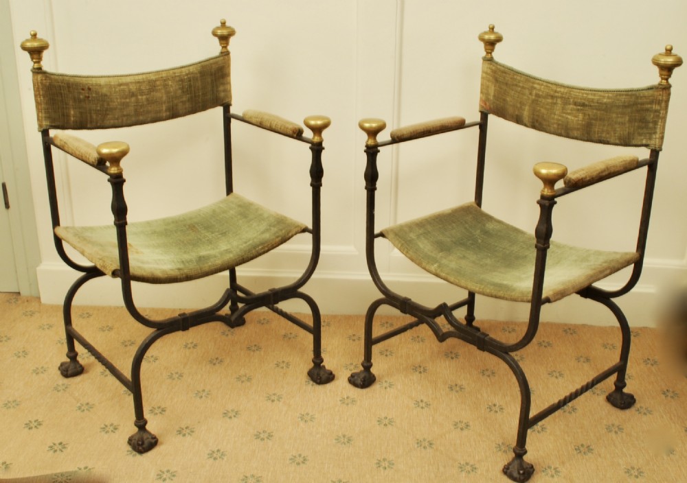 A decorative pair of 19th century Italian metal armchairs with paw feet 
