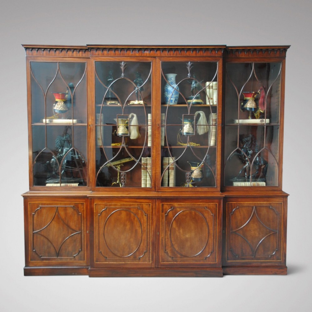 A FINE GEORGE III SHERATON DESIGN MAHOGANY BREAKFRONT BOOKCASE
