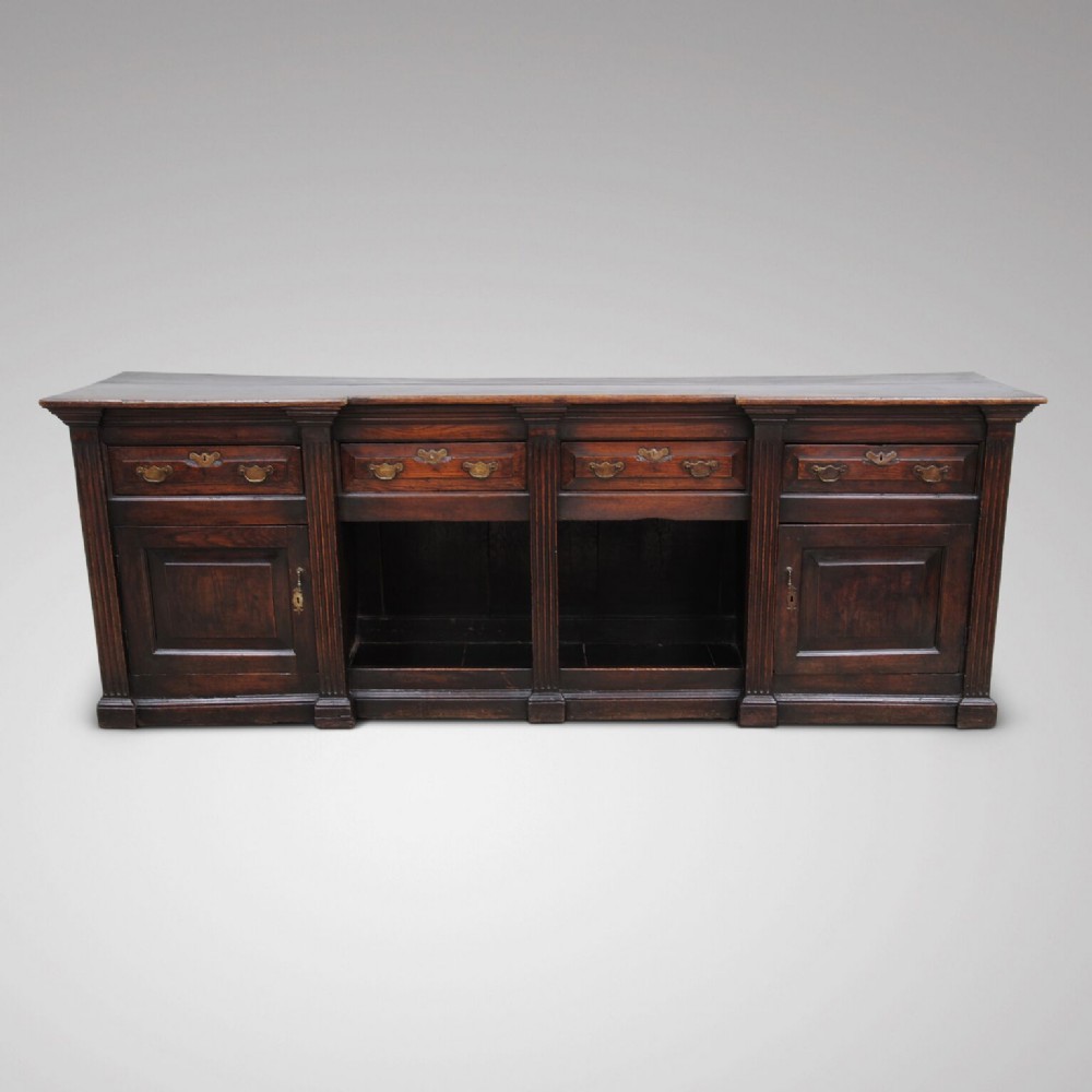 A unusual mid 18th century oak dresser base with dog kennel section.