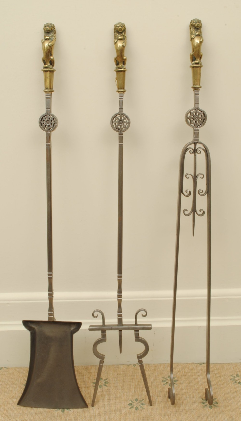 A LARGE AND IMPRESSIVE SET OF BRASS AND STEEL FIRE IRONS