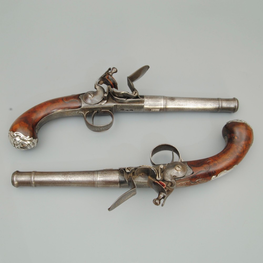 A PAIR OF 18TH CENTURY 22 BORE SILVER MOUNTED TURN OFF BARREL PISTOLS