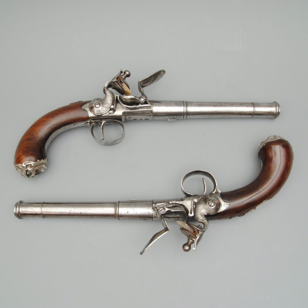 A RARE PAIR OF SILVER MOUNTED QUEEN ANNE PISTOLS