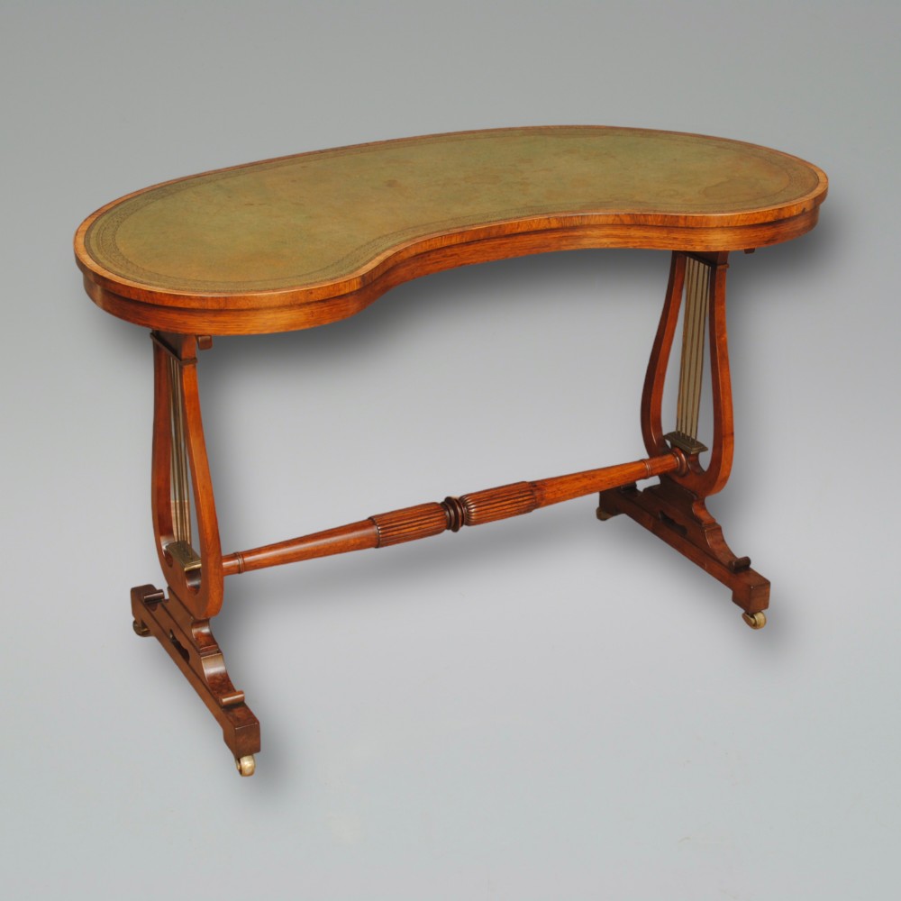 A REGENCY ROSEWOOD KIDNEY SHAPED WRITING TABLE