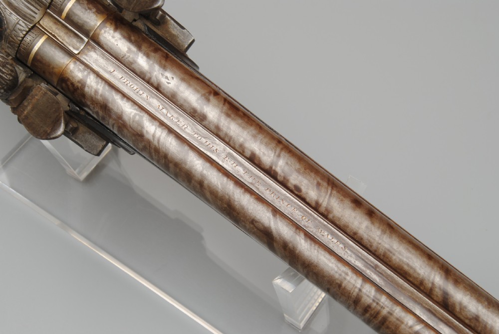 An antique double-barrel flintlock sporting gun featuring a dark walnut wood stock, twin steel barrels, and intricate lockwork. View III