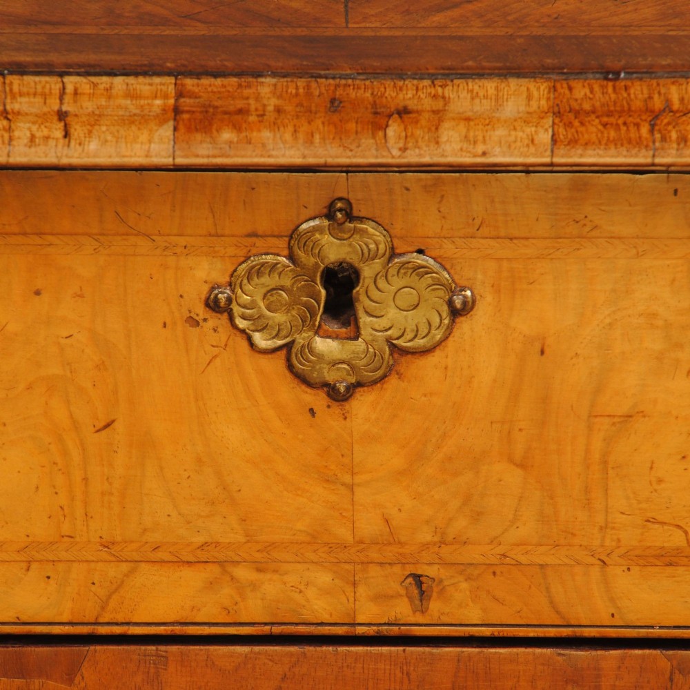 An 18th-century Queen Anne burr walnut kneehole desk featuring a long upper drawer, six side drawers, a central recessed cupboard, brass teardrop handles, and bracket feet. View IV
