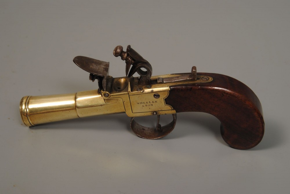 A pair of antique Georgian boxlock flintlock pistols featuring flared brass barrels, steel mechanisms, and dark wood grips. View IV