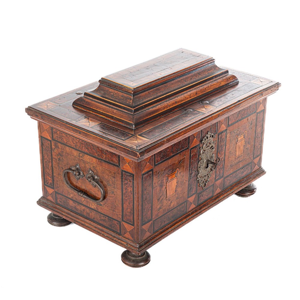 A late 17th-century Continental burr wood casket with a stepped lid, inlaid urn motifs, side iron handles, and a decorative keyhole escutcheon resting on bun feet. View III