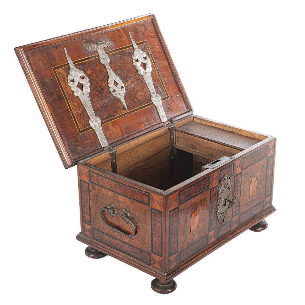 A late 17th-century Continental burr wood casket with a stepped lid, inlaid urn motifs, side iron handles, and a decorative keyhole escutcheon resting on bun feet. View IV