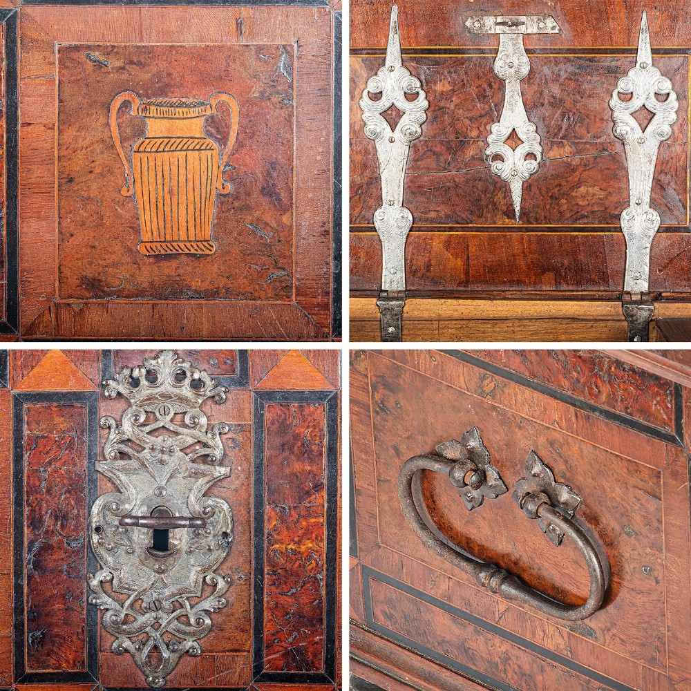 A late 17th-century Continental burr wood casket with a stepped lid, inlaid urn motifs, side iron handles, and a decorative keyhole escutcheon resting on bun feet. View VI