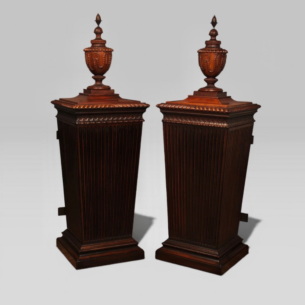 A pair of 18th-century mahogany dining pedestals featuring fluted square bodies, moulded bases, and detailed carved urn finials. View II